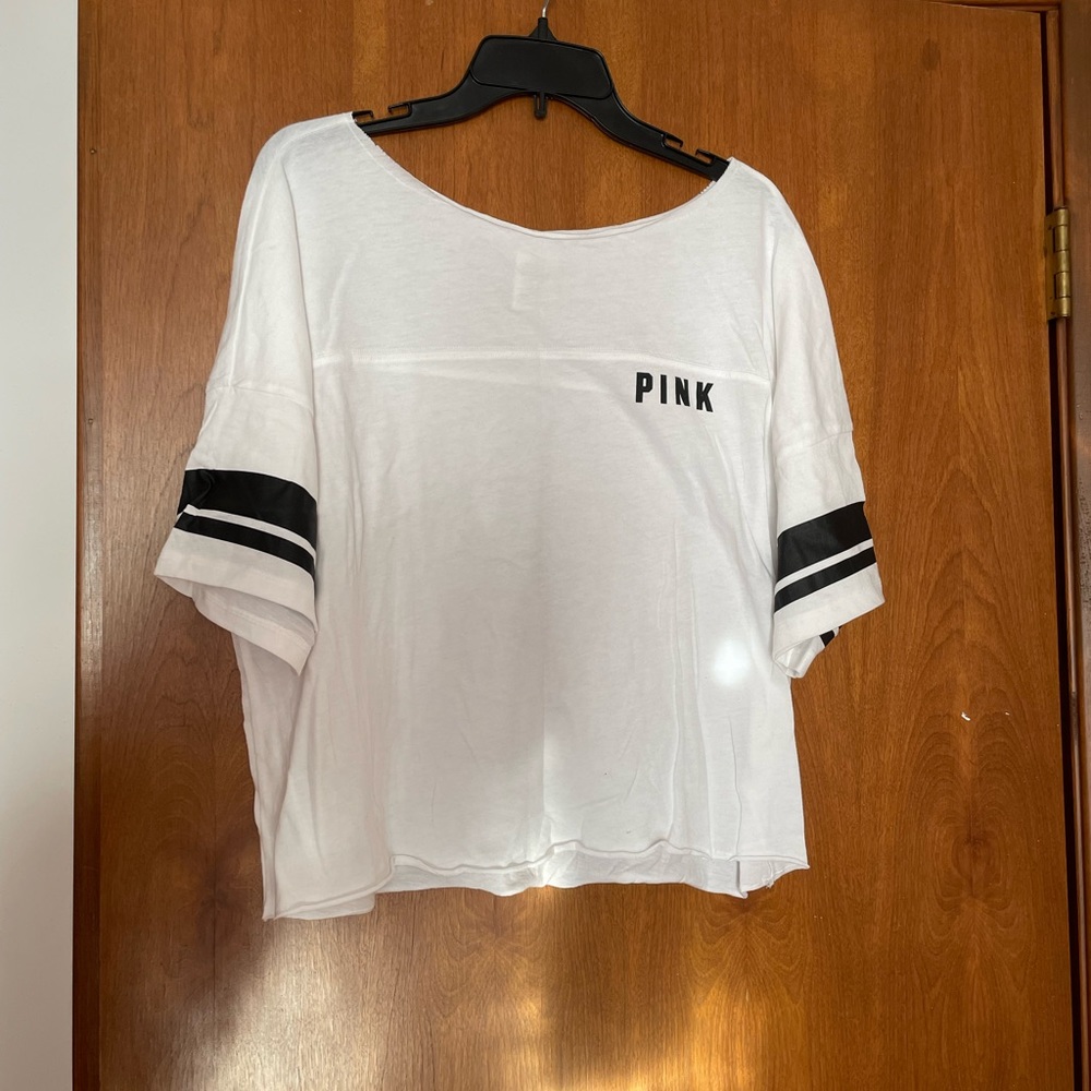 Pink white shirt with black detailing. Size L.
